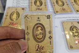 Small gold card held in hand, physical gold for personal investment